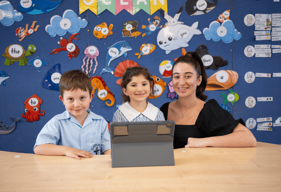 A photo of a teacher with two students happily learning and on the journey to 2025 NAPLAN success